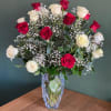 In glass vase, red and white roses with baby&rsquo;s breath. 
Standard size: