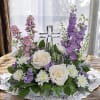 Lush flowers with a glass keepsake cross to show your loved one
