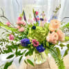 A colorfully delicate array featuring peach roses ,green hydrangea with other complimentary