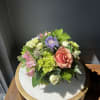 A beautiful spring arrangement in a glass bowl including mini green hydrangeas