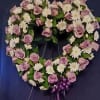 This lavender and white heart is full of beautiful lavender Roses accented