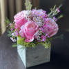 Blushing pink Roses accented by dainty pink and white Waxflower blooms and