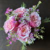 Blushing pink Roses accented by dainty pink and white Waxflower blooms and