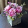 Blushing pink Roses accented by dainty pink and white Waxflower blooms and