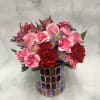 This arrangement has colorful Valentine&#039;s Day themed flowers arranged in a beautiful