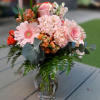 A Georgia classic mix of peach Roses, peach Carnations, Hypericum berries with