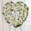 Open, heart-shaped arrangement of all white roses, hybrid lilies, football mums, carnations