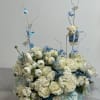Welcome a precious baby boy with this charming arrangement of white roses
