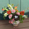 A celebration of new beginnings, this enchanting garden-style arrangement features vibrant tulips