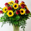This arrangement has a mixture of yellow sunflowers and red roses. Beautiful
