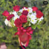 A red and white floral mix of white daisy. Red Roses. And