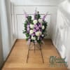 This elegant sympathy standing spray features a delicate blend of purple and
