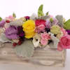 Keep things fun with this jewel toned flower box! Ranunculus, roses, and