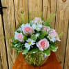 Pink mondial roses and white daisies with pittosporum and lepidium arranged in