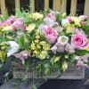 A lush mix of alstroemerias, tulips, and roses with green fillers in