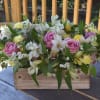 A lush mix of alstroemerias, tulips, and roses with green fillers in
