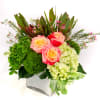 Bright and colorful arrangement, low compact design in white cubed vase. Cheer