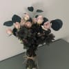 A gorgeous arrangement of fresh cut spray roses and fresh foliage, prepared