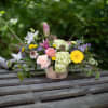 Elegantly designed garden style flowers arranged in a shabby chic novelty birch