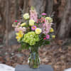 Spring flair arranged in an 8 inch clear glass Jordan vase. Pink