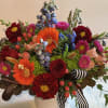 Seasonal bouquet with blooms in rich colors of burgundy, blues, orange, peach
