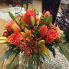 Orange roses, tulips and lillies perfect for a cool Autumn day to