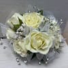 Classic spray roses intertwined with greens and matching ribbon create this elegant