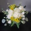 Designed in a glass cube with roses, alstroemeria, hydrangea, tulips, accent blooms