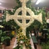 Large and prestigious Celtic cross with mums and orchids.