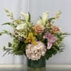 Like a gentle stroll through a sun-dappled meadow, this wildflower arrangement captures