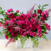 Handcrafted in a square ceramic vase, this collection of premium hot pink