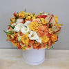 Enjoy this arrangement all year long with yellow, pinks, and peach flowers.