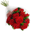 A dozen red roses with greens and filler flower wrapped in a
