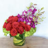 A celebration of luxury and life, this large and jewel toned arrangement
