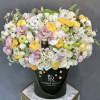 Festive arrangement of white flowers, fresh apples, and honey in our signature