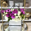 Stylish and fun, this arrangement showcases hydrangeas, sweetheart roses, lisianthus, orchids, and