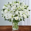 Description
Express your sincere condolences with our elegant all-white arrangement of roses, lilies