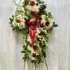 This serene floral cross offers a graceful symbol of comfort and eternal