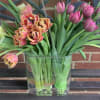 This awesome arrangement of tulips features an oval vase and three colors
