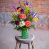 A wonderful florist mix and match style arrangement created in a cylindrical