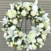 White funeral wreath offers peaceful wishes of heartfelt sympathy with each delicate