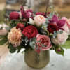 An absolutely stunning fresh flower arrangement full of premium and garden roses
