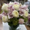 A classic and soft arrangement of premium seasonal blooms in a muted