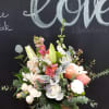 Mixture of serene green and soft colors of flowers in wooden box.