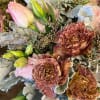 A modern combination of Lisianthus wrapped in mesh. This is a hand-tied