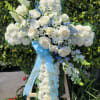 White carnation cross with a mix of all white flowers in the