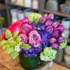 An eye-catching arrangement featuring a radiant mix of tulips, rich purple hydrangeas