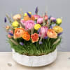 Celebrate the new season with this charming arrangement full of spring pastels.