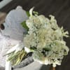 A graceful arrangement of white roses, calla lilies, and hydrangeas, this bouquet