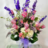 Arrangement of fresh cut flowers designed in a glass vase. Colors can